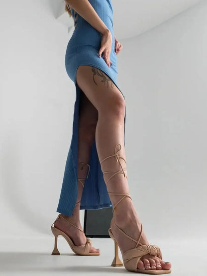 Ocean Lace Midi Dress featuring a daring side slit and elegant strappy heels, perfect for summer weddings and formal events.