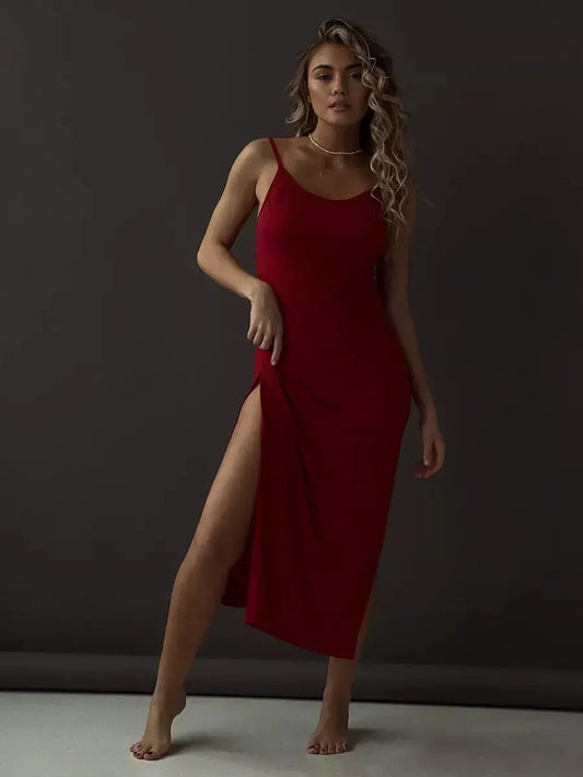 Model showcasing the Scarlet Lure Midi Dress in red, featuring a side slit and sleek design, perfect for parties or formal events.