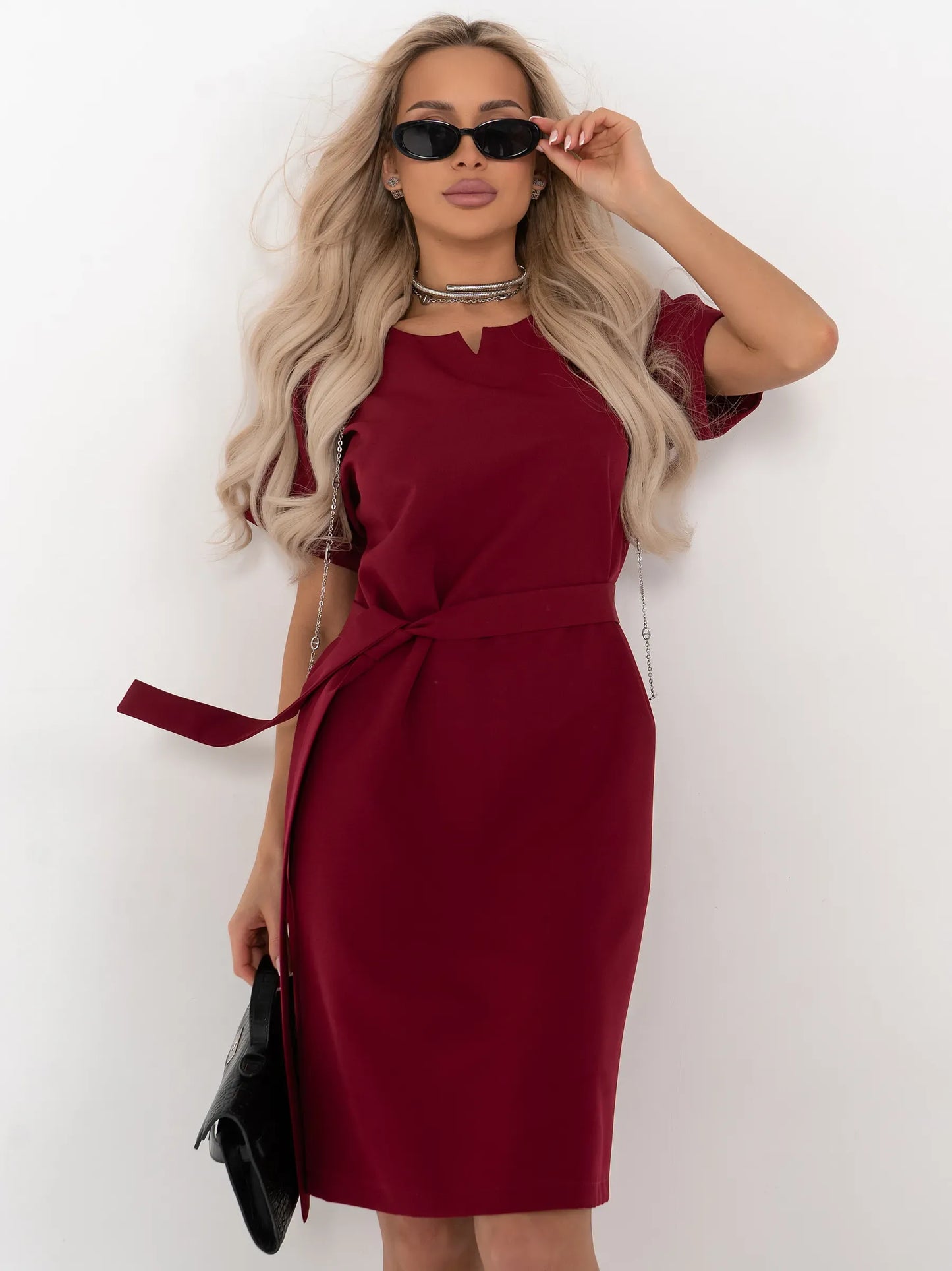 Crimson Code mini dress in wine-red, featuring structured sheath silhouette, notched neckline, and detachable belt.