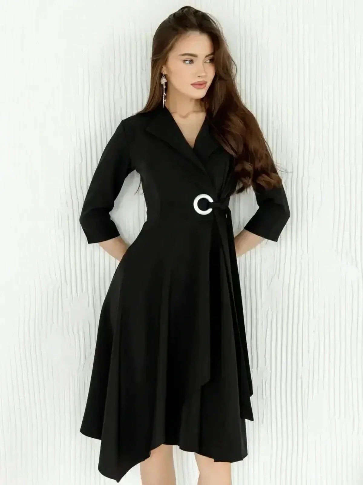 Chic black midi dress with wrap silhouette, asymmetric hem, and silver-tone ring detail, perfect for formal occasions.