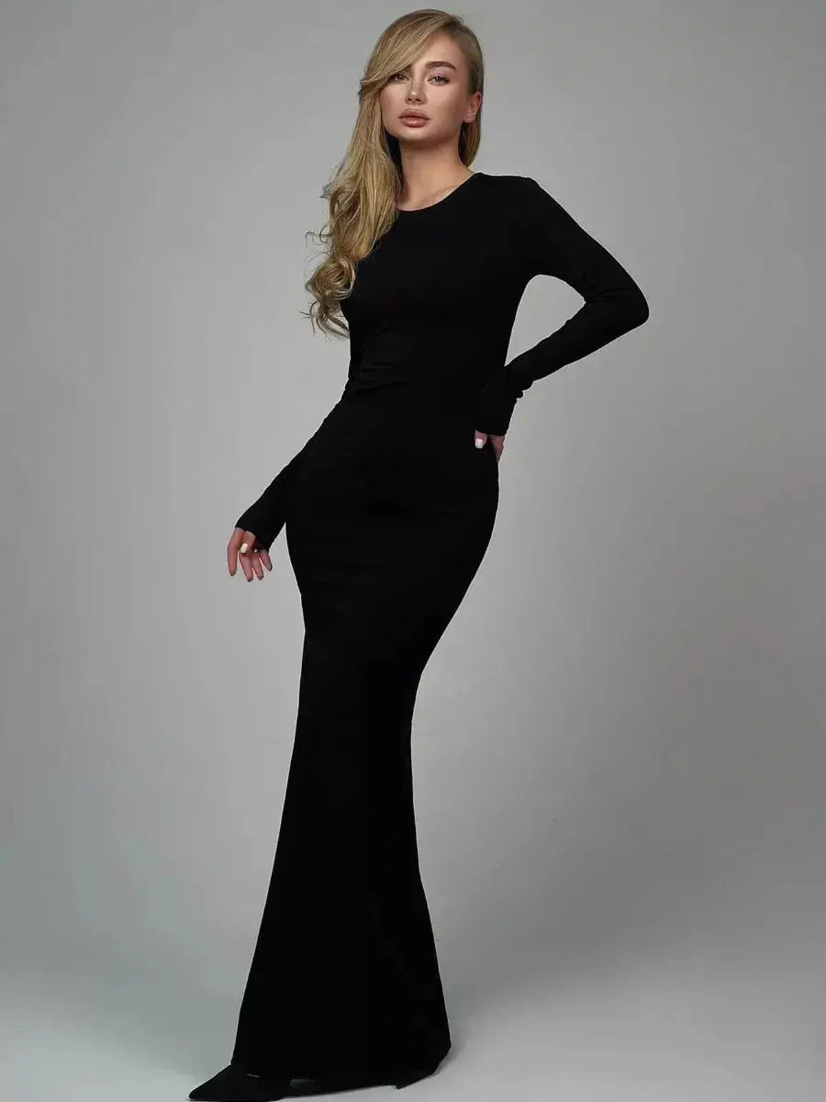 Model showcasing the Sculpted Elegance Maxi Dress in black, a seamless and breathable formal dress.