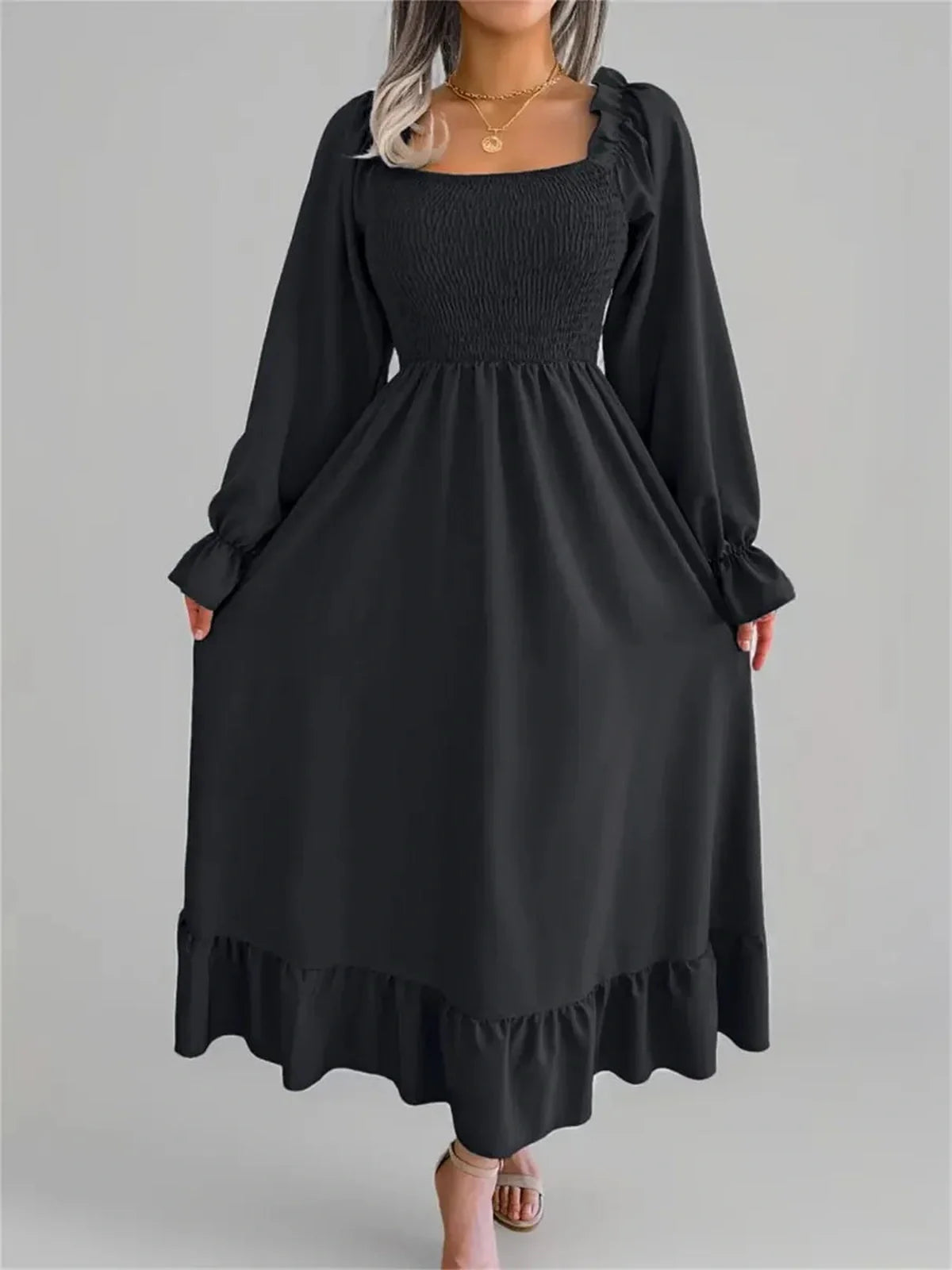 Elegant black Ruffle Grace Midi Dress featuring a smocked bodice and romantic long sleeves, perfect for formal occasions.