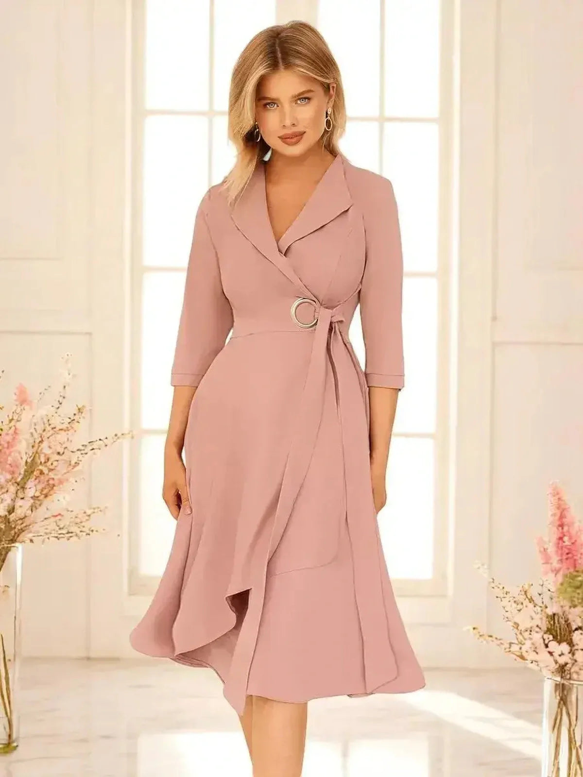 Blush Charm Midi Dress featuring a draped wrap silhouette, ring buckle belt, and feminine flow, perfect for weddings and formal events.