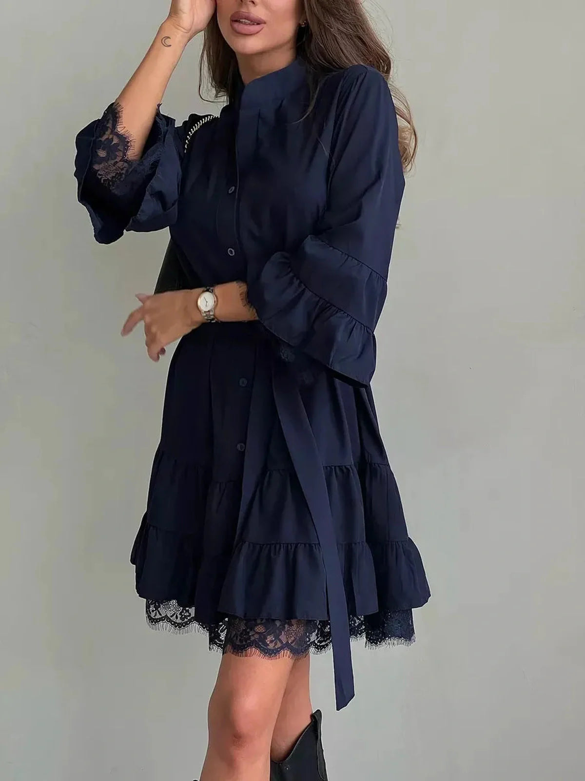 Navy blue lace flare mini dress featuring oversized silhouette and tiered ruffles, ideal for summer and special occasions.