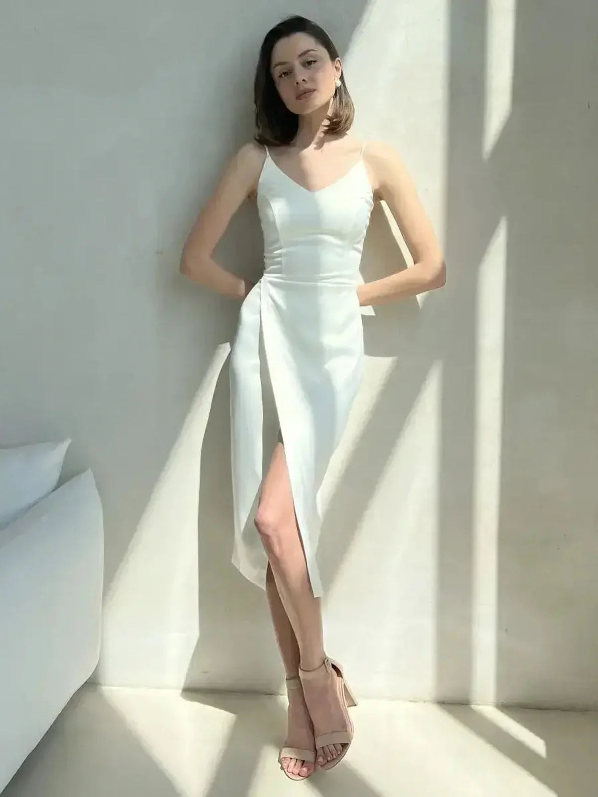 Elegant ivory satin midi dress with wrap detail, perfect for weddings, cocktail events, and formal occasions.
