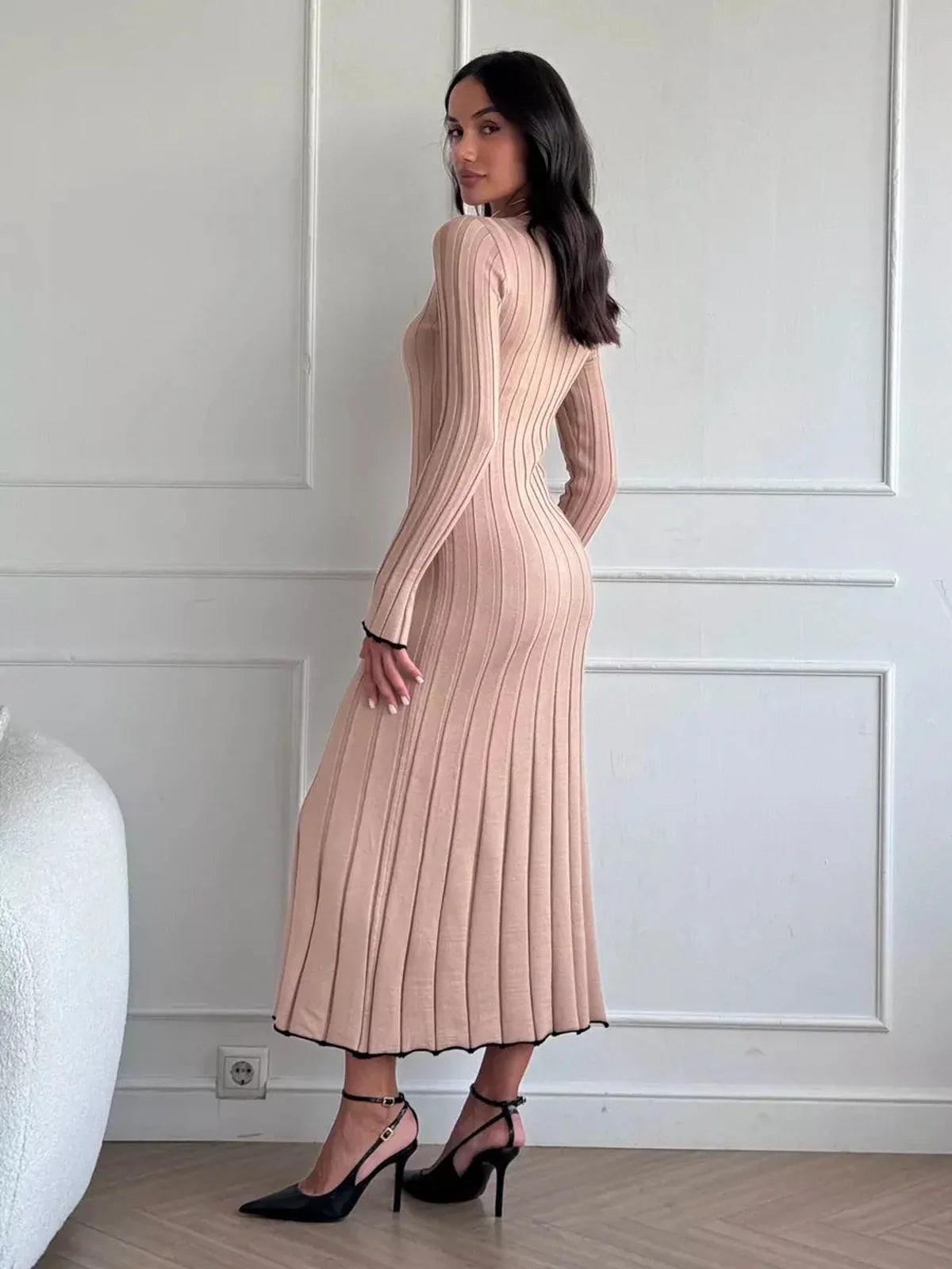 Model showcasing the Sahara Curve Maxi Dress in sandstone beige, featuring a ribbed texture and elegant full-length cut.