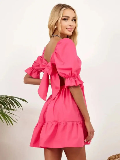 Pink Candy Bow mini dress with elasticated neckline, perfect for summer parties and wedding guest occasions.