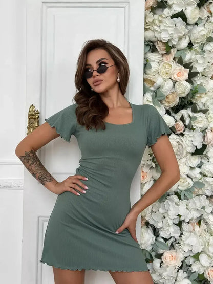 Sage Aura Mini Dress with flutter sleeves, perfect for summer styling and wedding guest occasions.