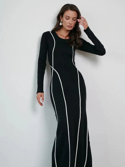Elegant black maxi dress with white contrast piping, perfect for formal events and special occasions.