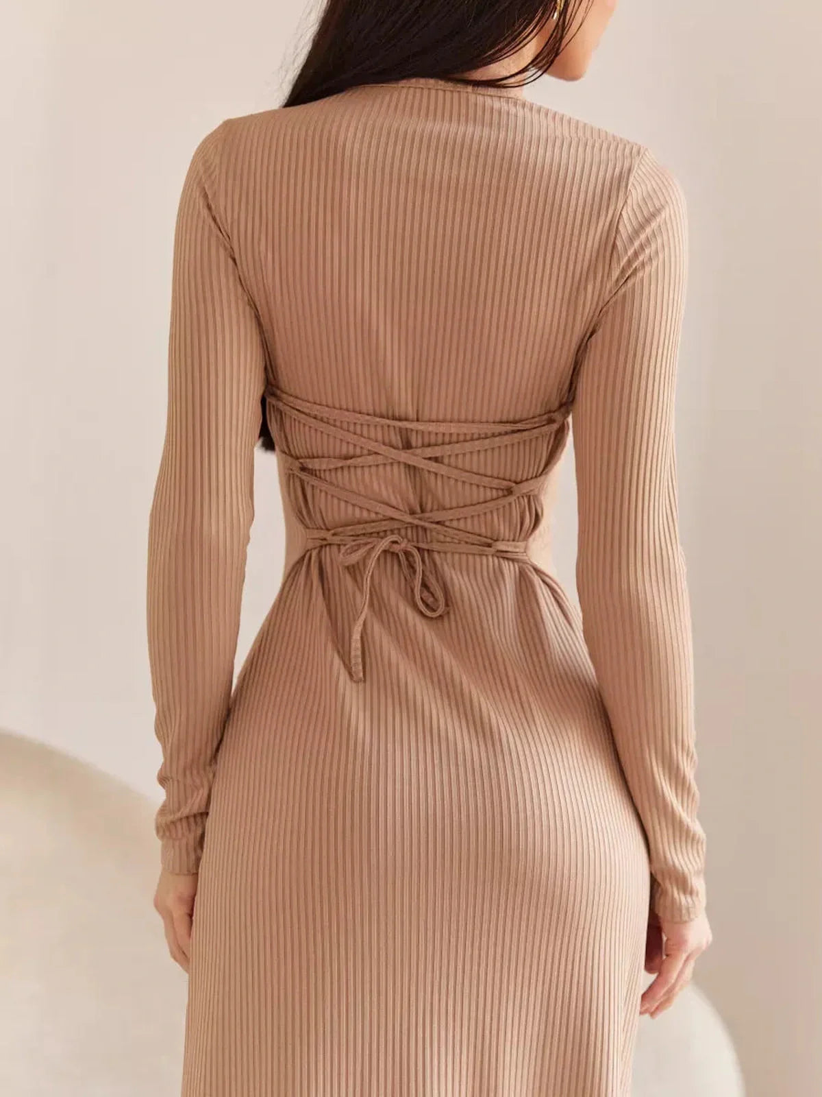 Back view of the Laced Elegance Midi Dress showcasing its lace-up waist detail and long sleeves, perfect for formal occasions.