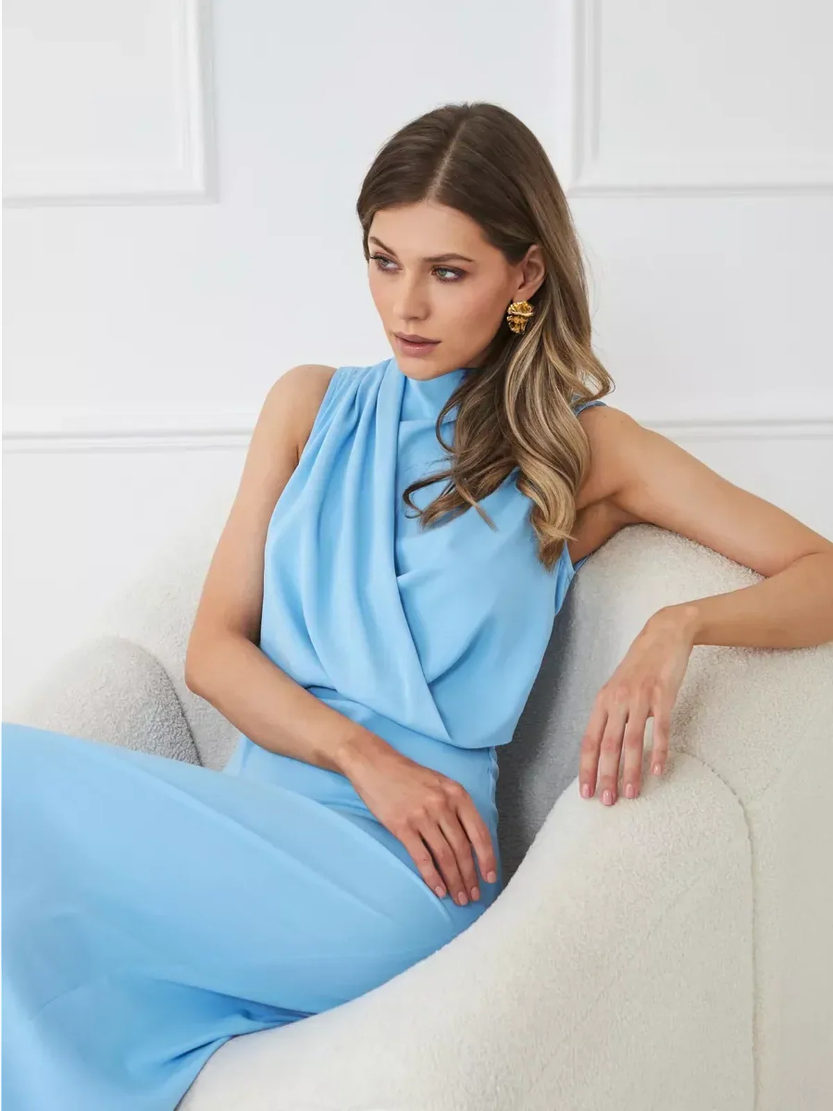 Model wearing Sculpted Grace Maxi Dress in blue, showcasing draped silhouette and elegant styling.