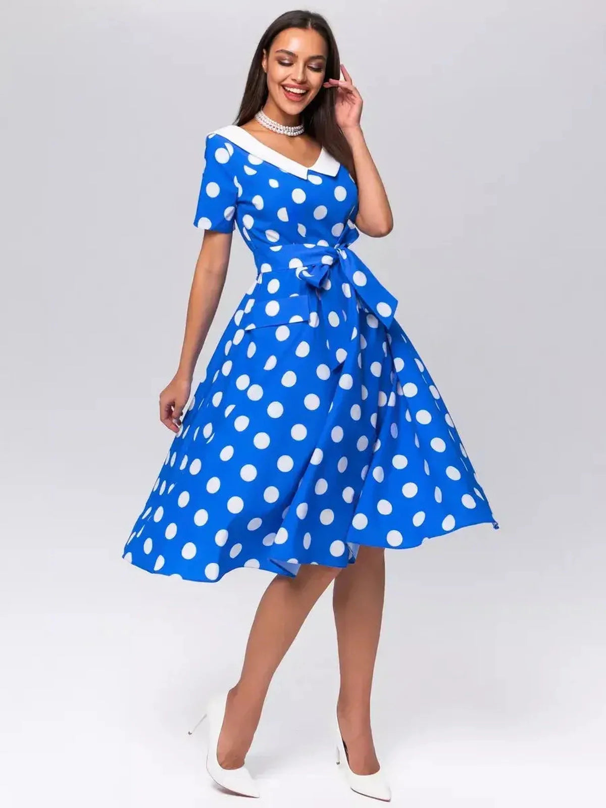 Midi Dress Azure Dots featuring white polka dots, V-neckline, tie belt, and A-line silhouette, perfect for summer occasions.
