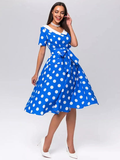 Midi Dress Azure Dots featuring white polka dots, V-neckline, tie belt, and A-line silhouette, perfect for summer occasions.
