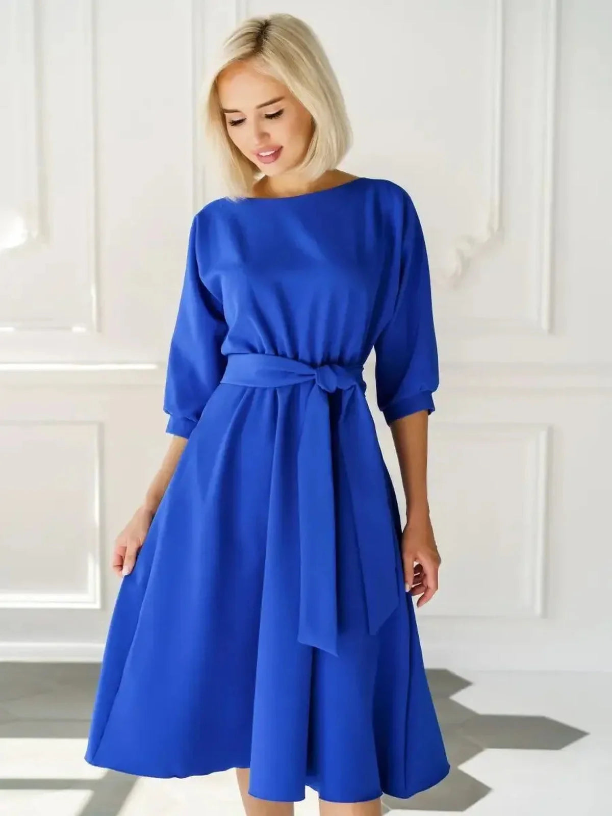 Sapphire belted midi dress in electric blue, featuring a structured silhouette and elegant A-line shape.