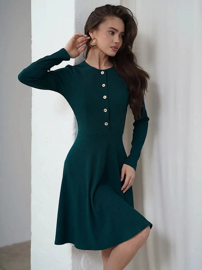 Emerald mini dress with long sleeves, ribbed texture, and button placket, perfect for weddings and formal occasions.