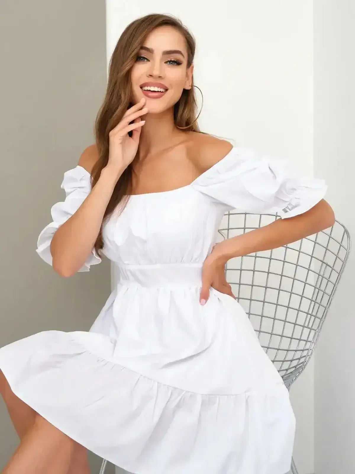 Model in a stylish off-shoulder white dress with puff sleeves, perfect for summer, weddings, and special occasions.