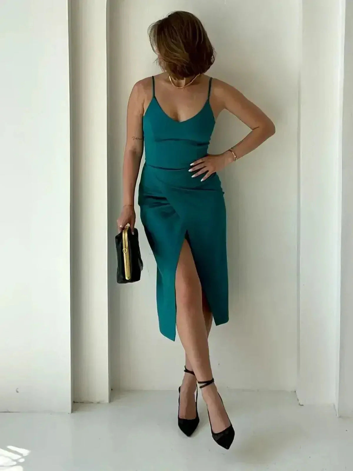 Emerald green Lustre Midi Dress featuring sultry thigh-high slit, perfect for weddings and formal occasions.