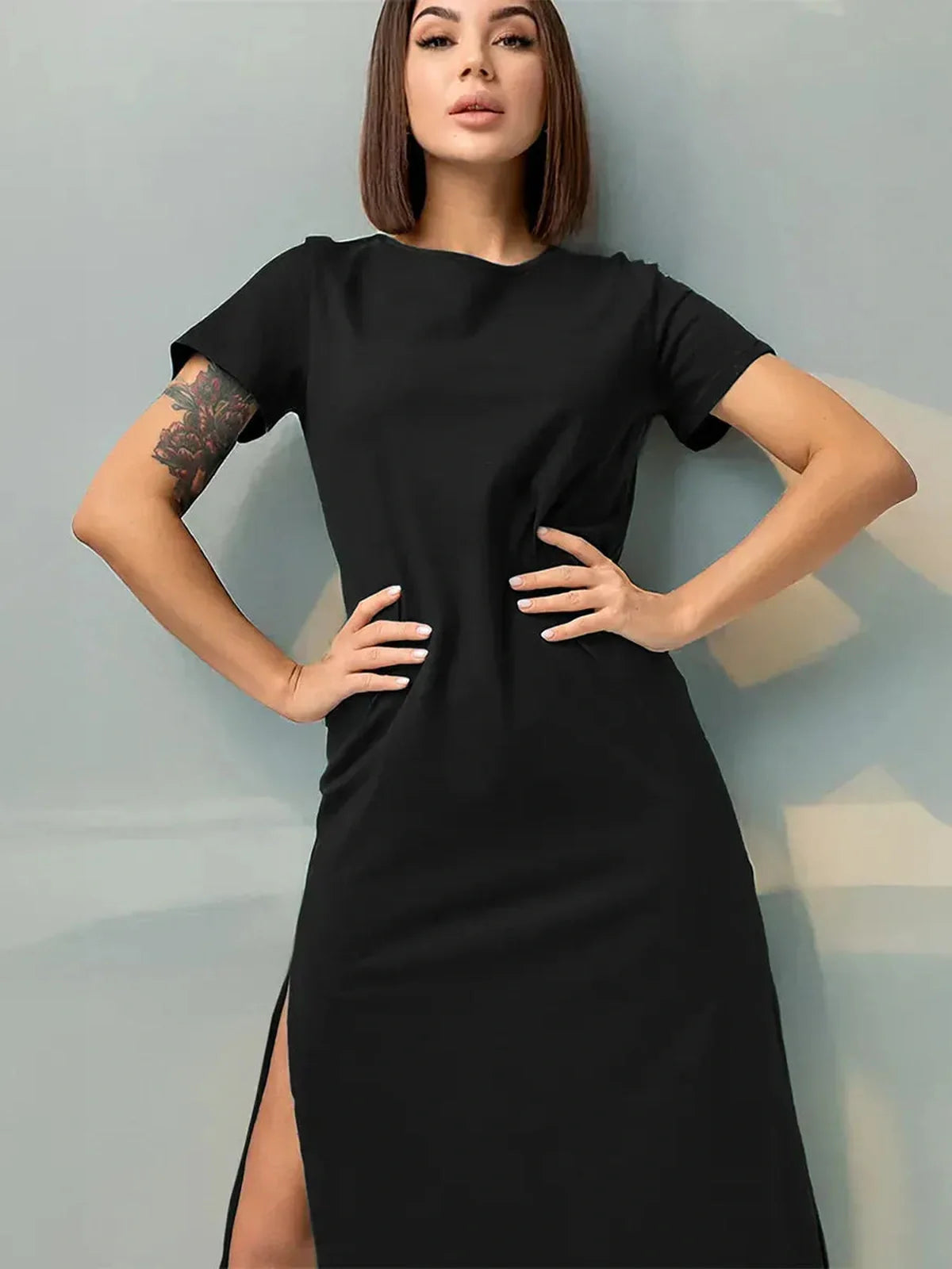 Black Essential Midi Dress with sleek side slit, perfect for casual or formal events.