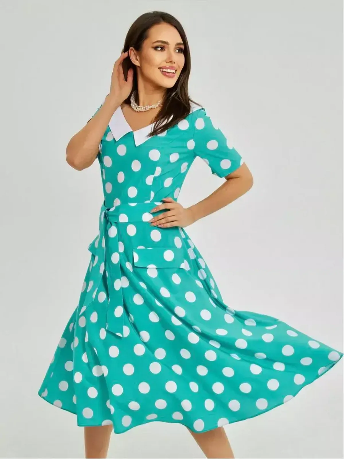 Turquoise polka dot midi dress with white collar and tie waist, ideal for summer events and formal occasions.