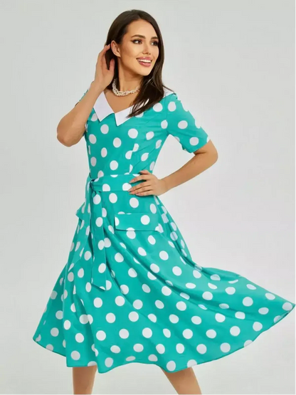 Turquoise polka dot midi dress with white collar and tie waist, ideal for summer events and formal occasions.