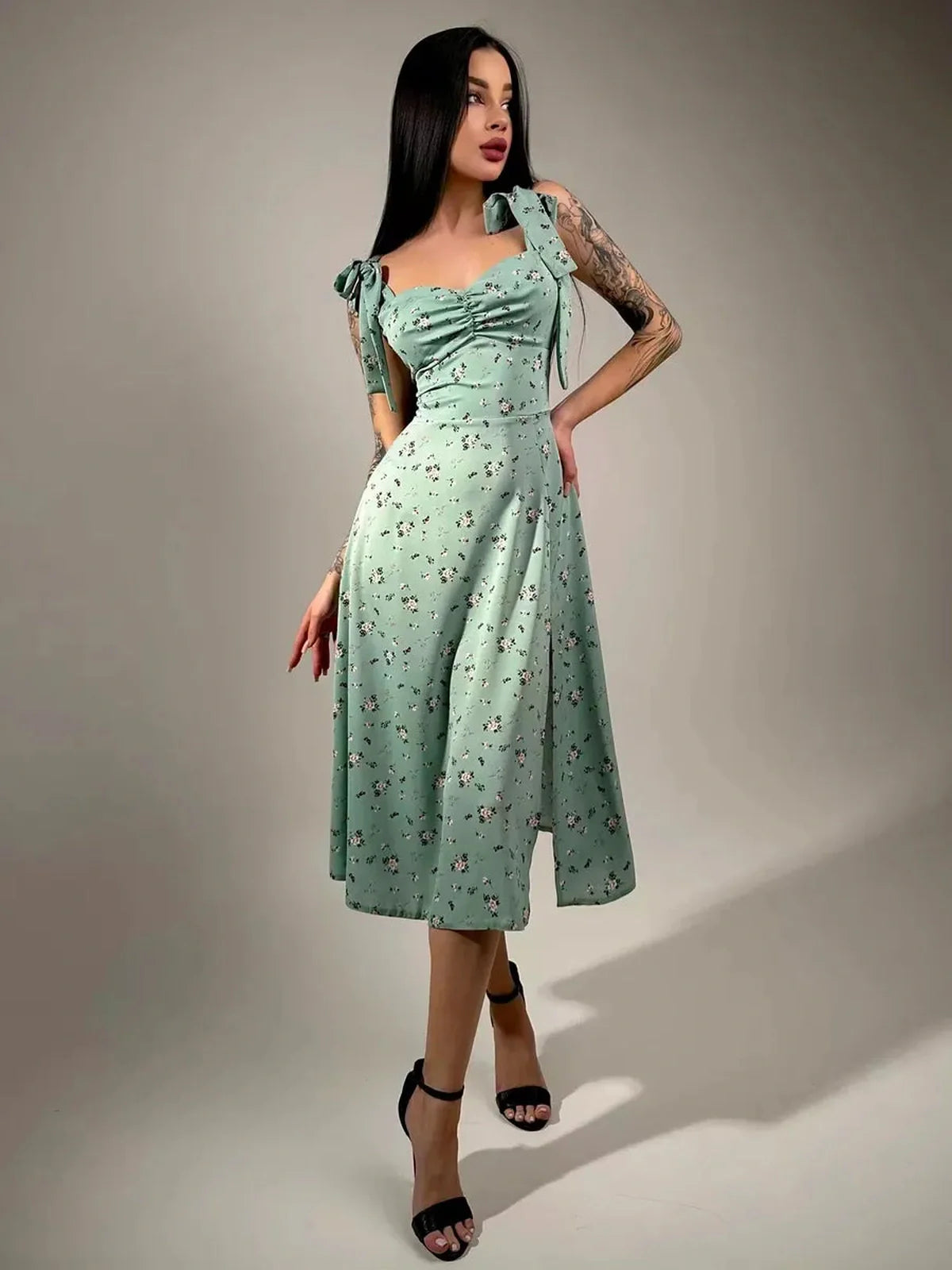 Flora Grace Midi Dress in mint green with floral print, featuring a ruched bodice and bow straps, ideal for weddings and spring events.