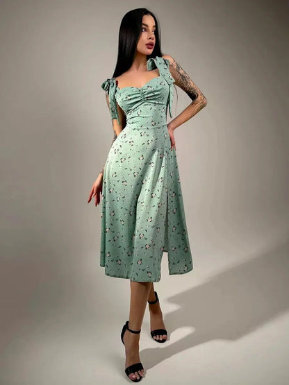 Flora Grace Midi Dress in mint green with floral print, featuring a ruched bodice and bow straps, ideal for weddings and spring events.
