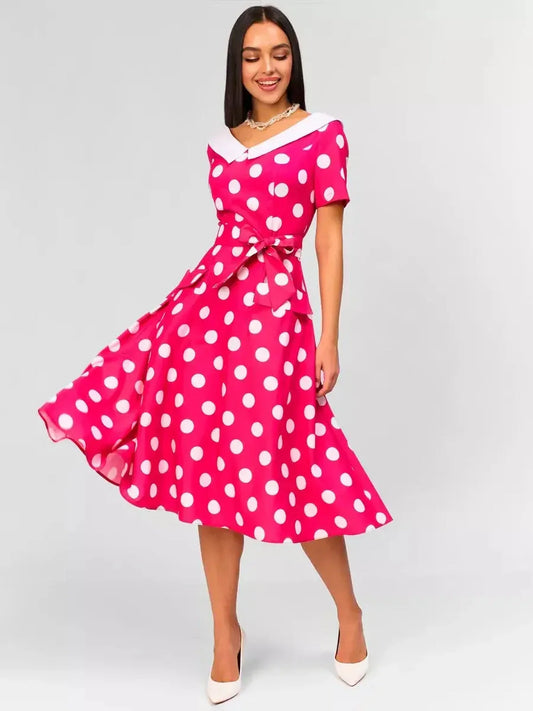 Monaco Charm Midi Dress featuring pink polka dots, white collar, and flattering tie waist, perfect for summer events.
