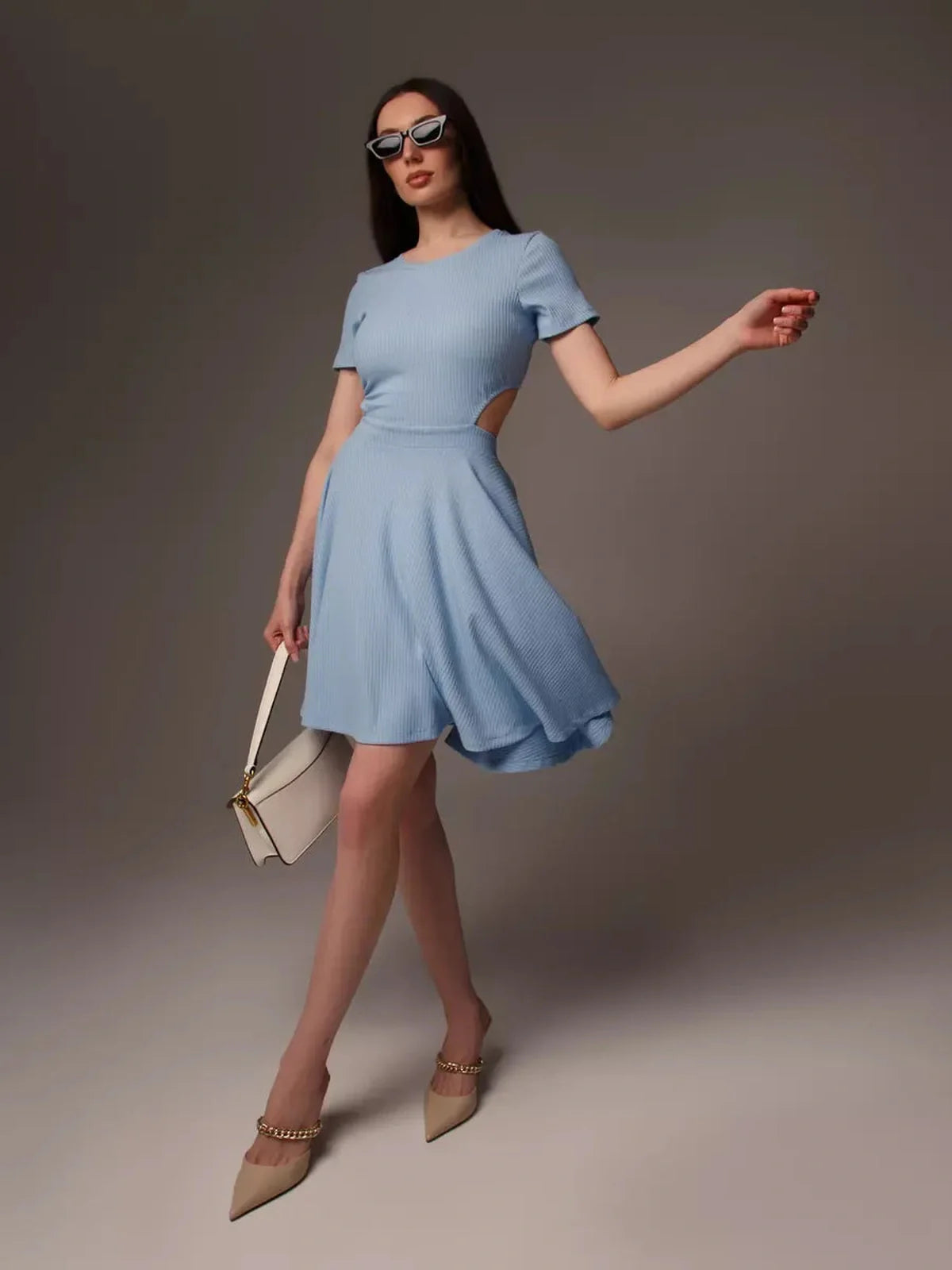 Skyline Bloom mini dress in light blue with cut-out waist, perfect for summer events and stylish outings.