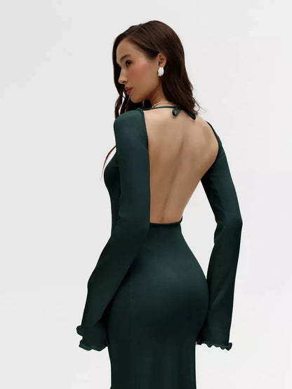 Model showcasing the open back and flounced sleeves of the green Serenity Knit Midi Dress.