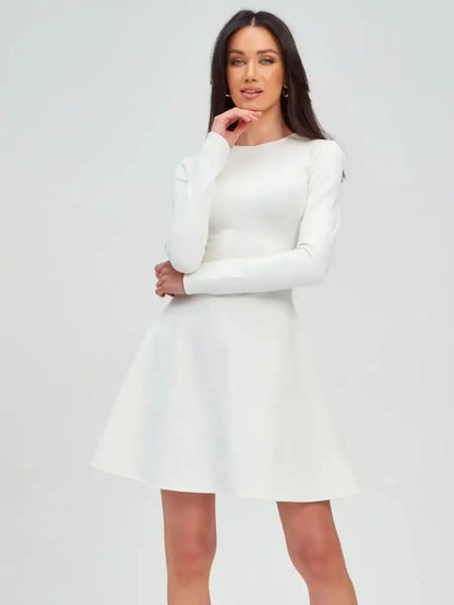 Model showcasing the Ivory Sculpt Dress, an elegant white mini dress, perfect for weddings and formal occasions.