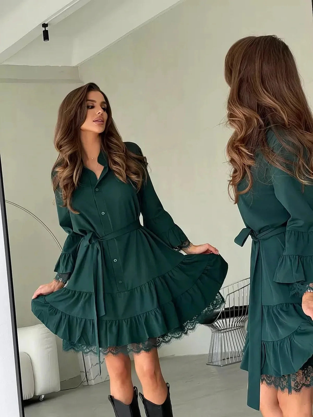 Lace Aura Mini Dress in deep emerald with lace trim, showcasing a flowy tiered silhouette for elegant occasions.