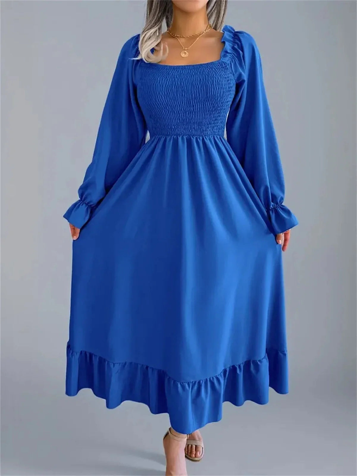 Serena Midi Dress in blue featuring a smocked bodice and romantic ruffle details, perfect for summer or formal occasions.