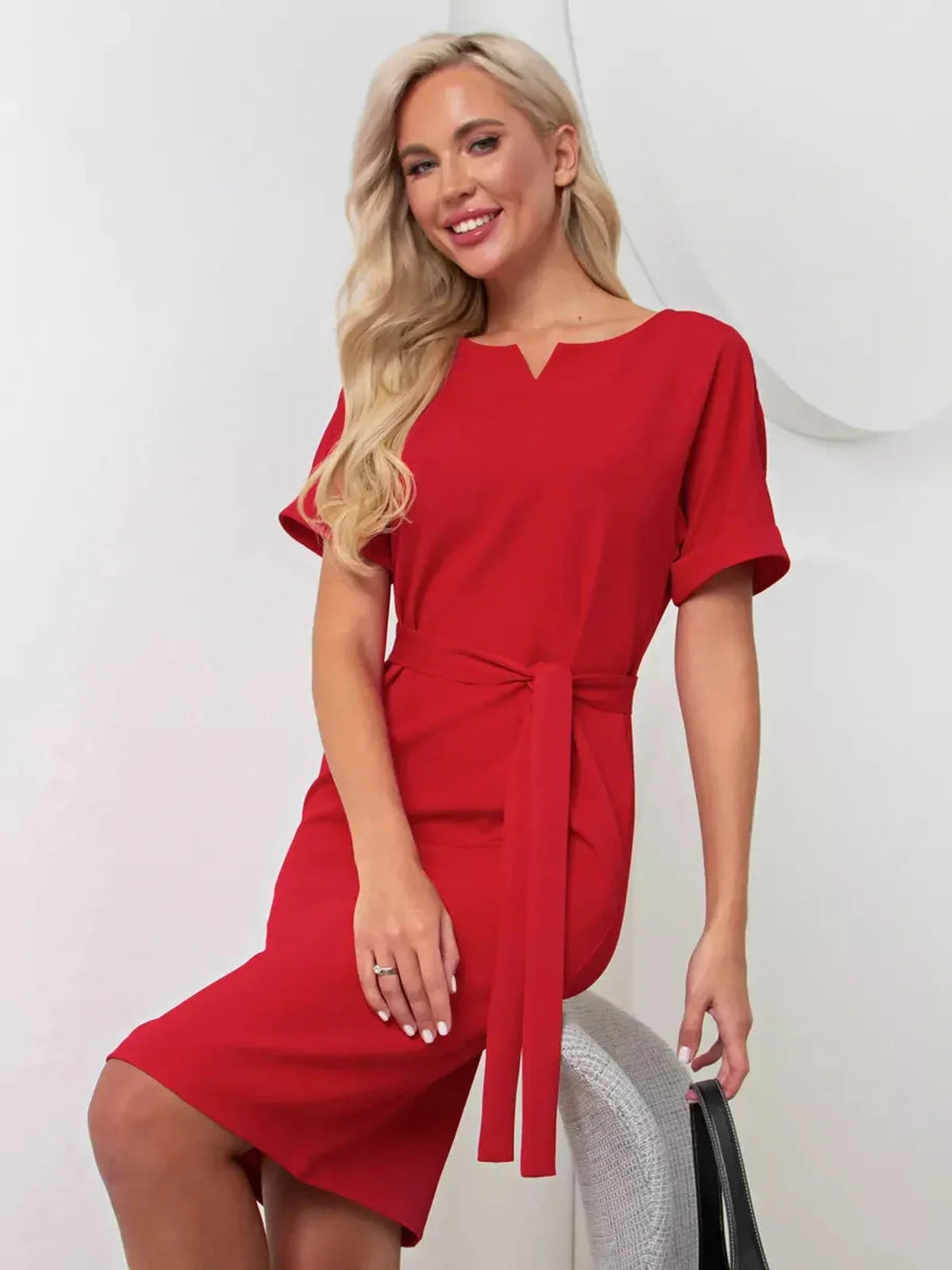 Stylish red mini dress with a belt, perfect for weddings, parties, and summer events, showcasing a modern silhouette.