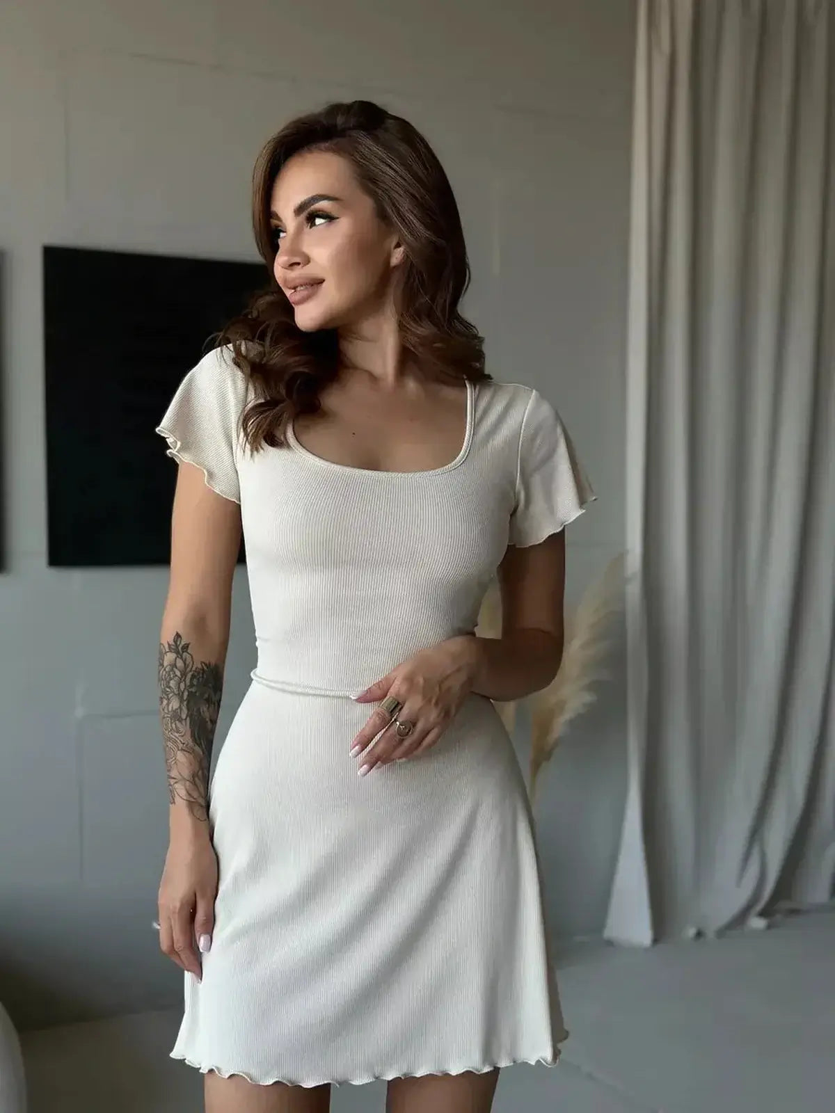 Ivory Belle Mini Dress featuring a lace-up back, perfect for summer outings and wedding guest attire.