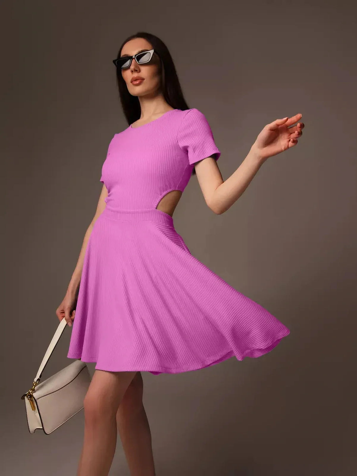 Model wearing a playful fit-and-flare pink cutout charm mini dress, showcasing a breezy skirt and stylish accessories.