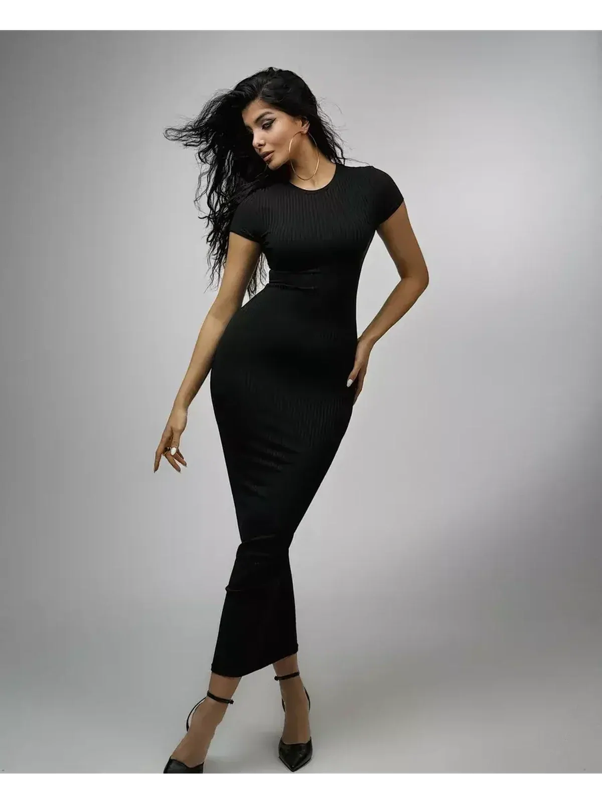 Obsidian Maxi Dress in black, showcasing a sculpted silhouette and elegant rib knit design, perfect for formal occasions.
