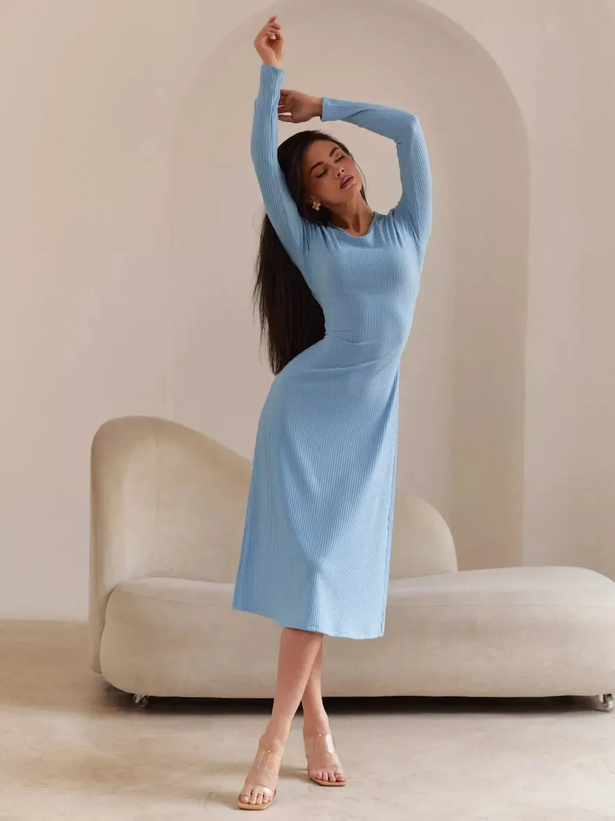 Model showcasing the Sculpted Grace Midi Dress in soft blue, highlighting its form-fitting design and elegant silhouette.