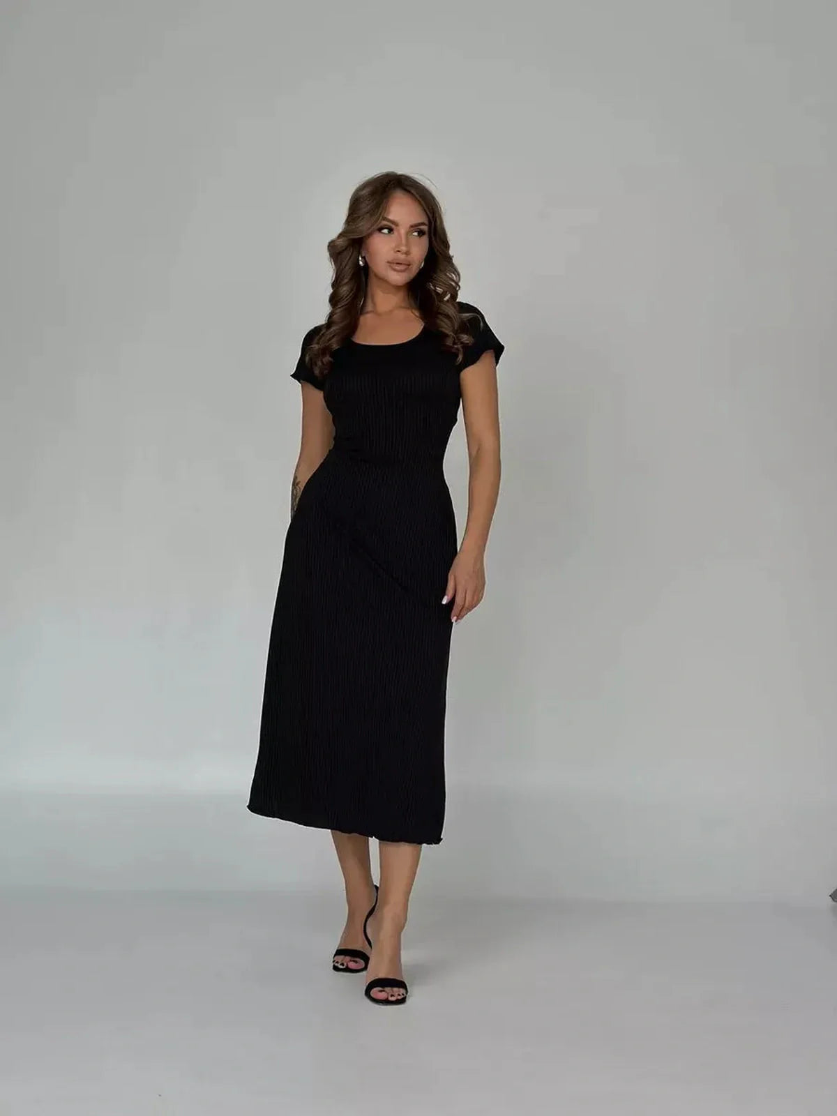 Elegant black Corset Grace Midi Dress with ribbed texture and sculpting back, perfect for weddings or cocktail events.