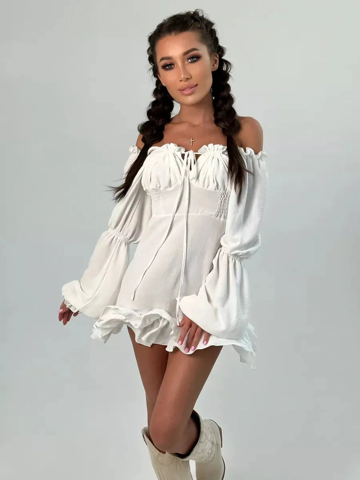 Model showcasing the Ruffle Bloom Mini Dress, featuring off-shoulder design, voluminous sleeves, and delicate ruffles.