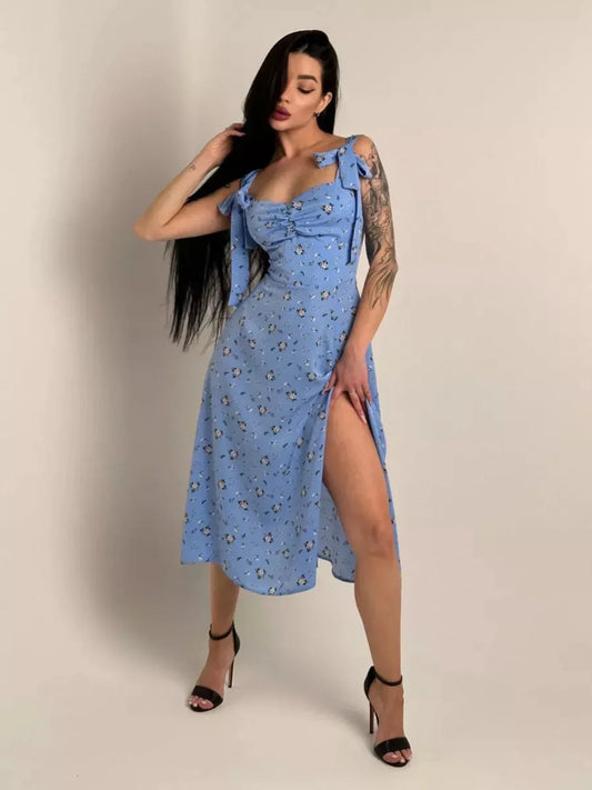 Model in a floral charm midi dress with shoulder ties and thigh slit, showcasing a chic summer style.