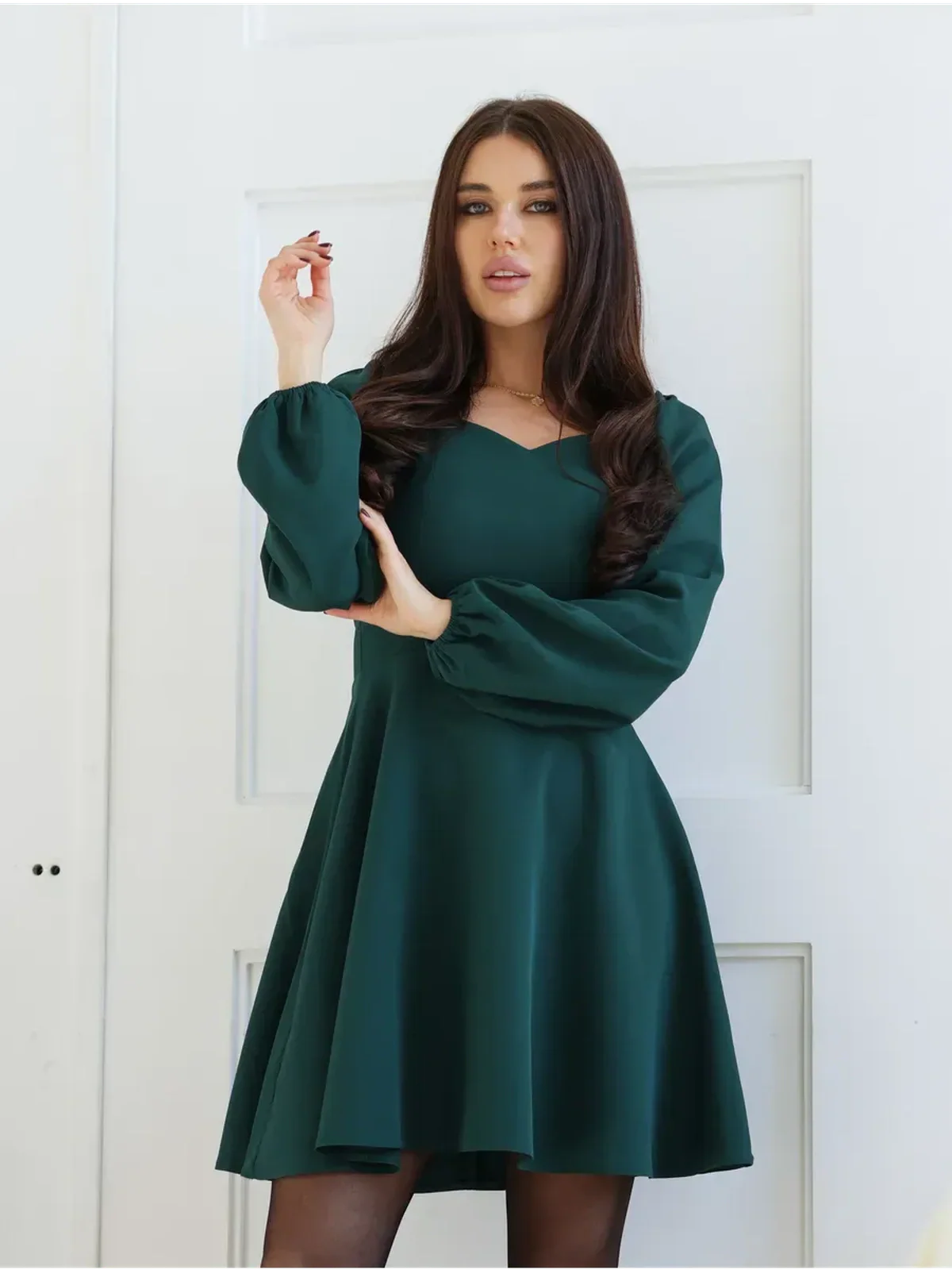 Emerald Grace mini dress featuring a flattering fit-and-flare silhouette with long puff sleeves and a sweetheart neckline.