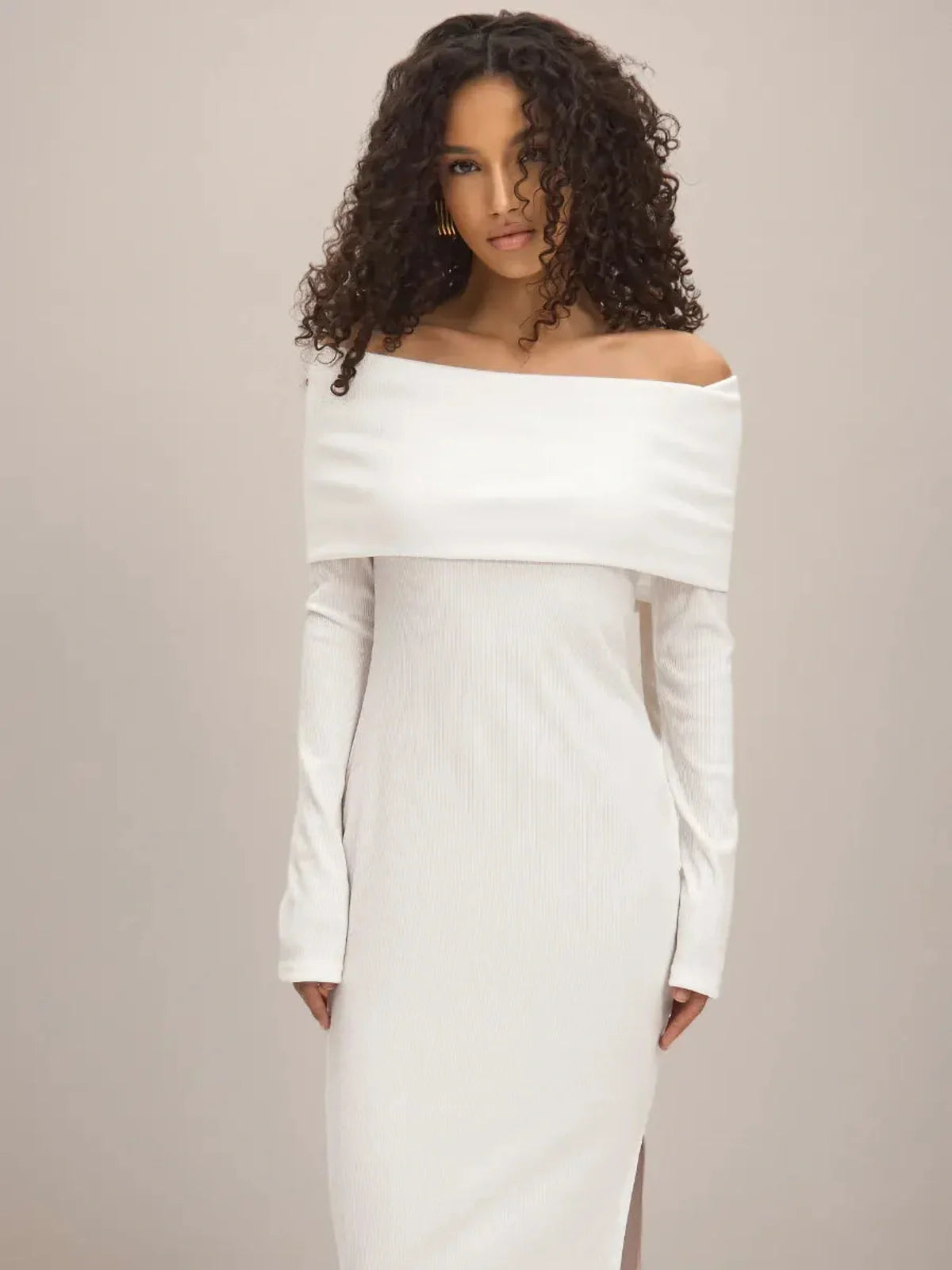 Model wearing the Sculpted Grace Maxi Dress, featuring an off-shoulder neckline and elegant side slit.