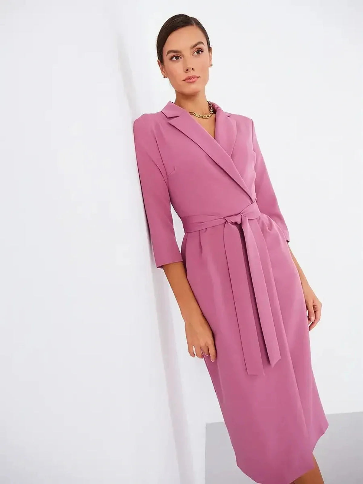 Blush wrap midi dress with belted waist, three-quarter sleeves, and notched collar, perfect for formal occasions.