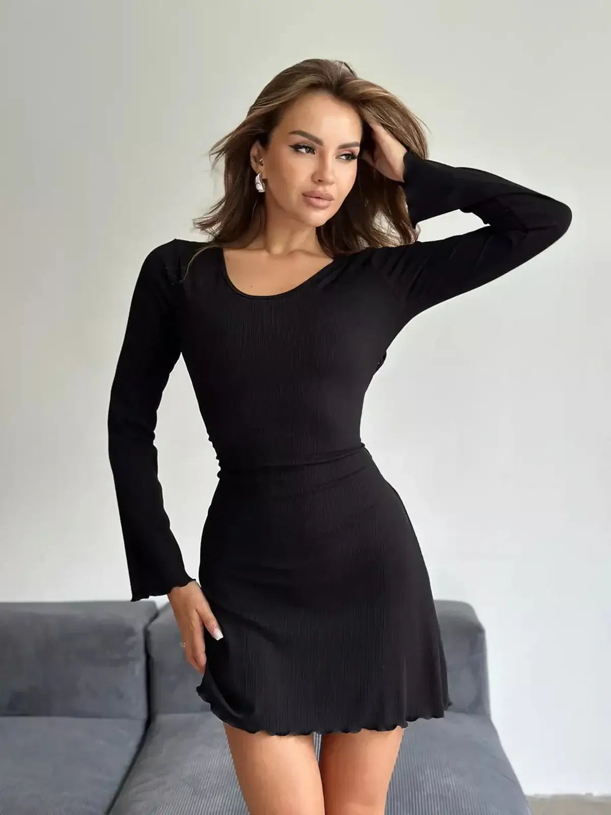 Noir Curve Mini Dress in black ribbed knit, featuring a fitted shape, long sleeves, and adjustable lace-up waist for a trendy look.
