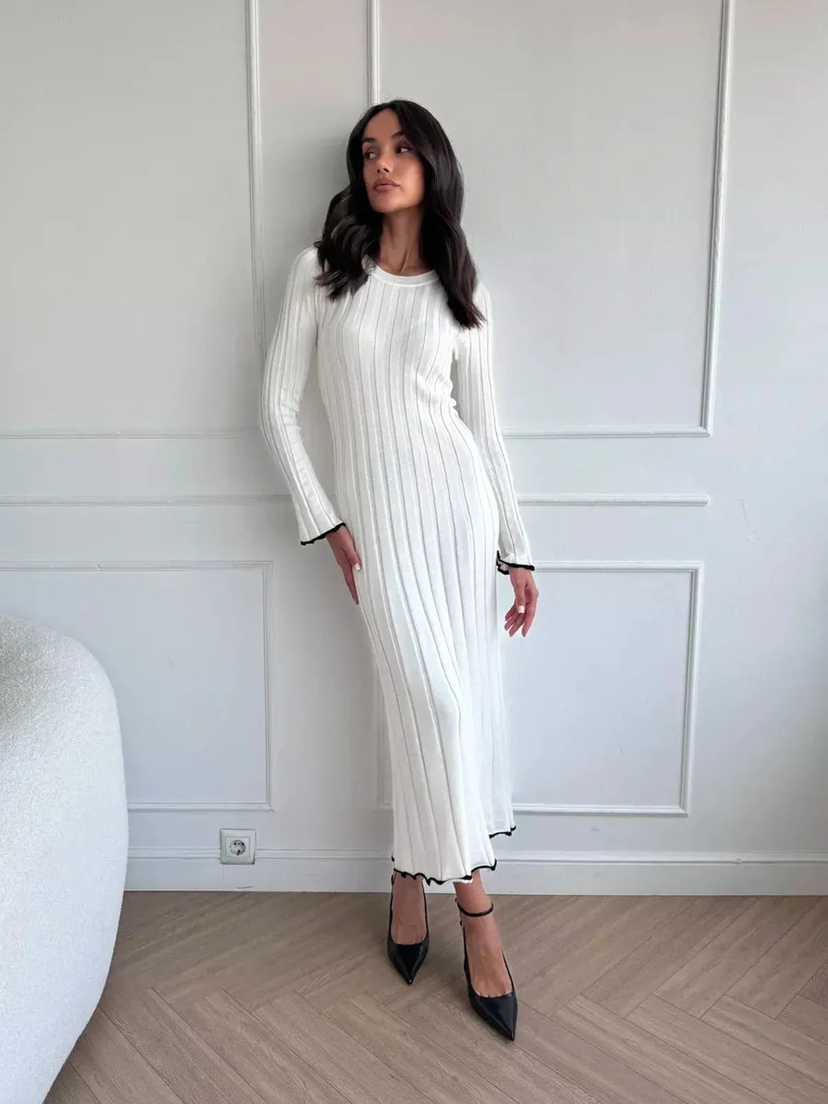 Model showcasing the Ivory Grace Maxi Dress, a chic long white dress with ribbed texture and ruffle trim.