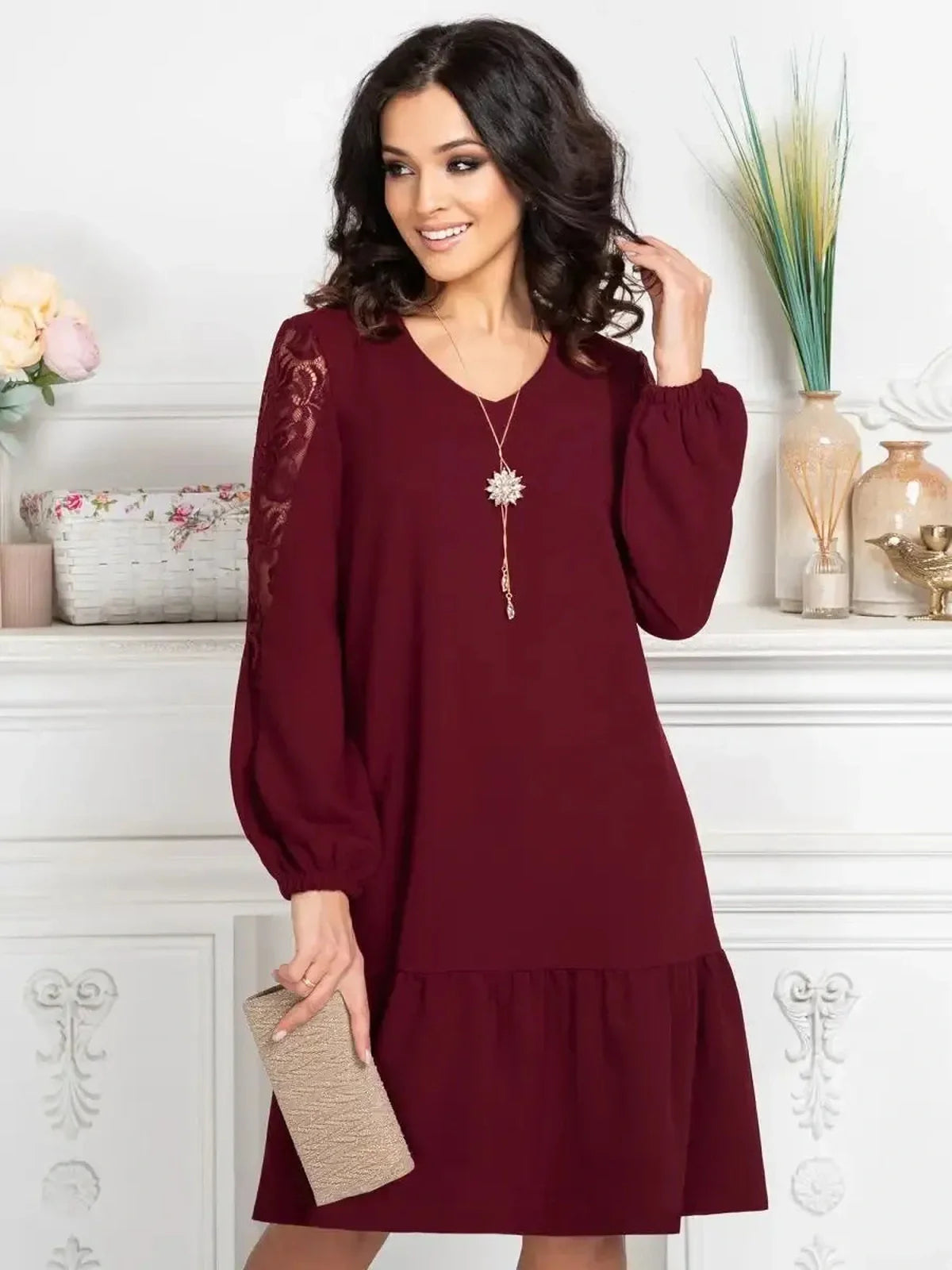 Model wearing a Lace Ruby mini dress with sheer lace sleeves, perfect for weddings or formal occasions.