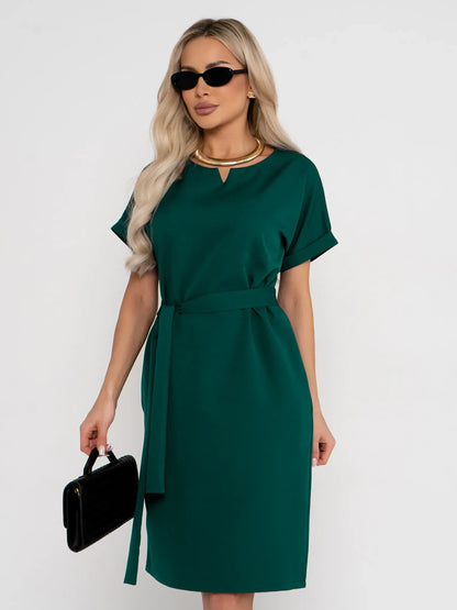 Emerald Mode green mini dress featuring a notched neckline and fabric belt, ideal as a wedding guest or cocktail dress.