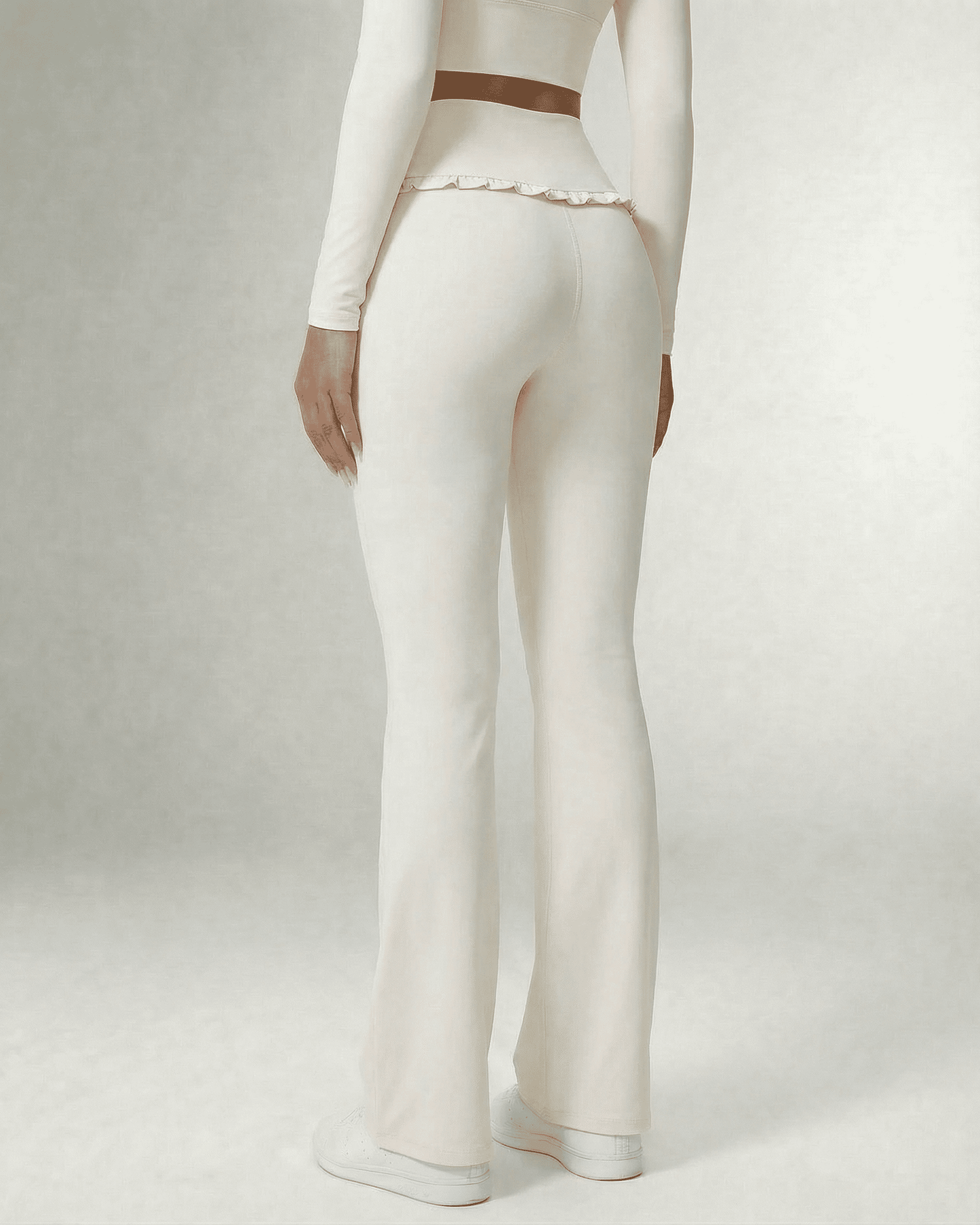 Celeste Leggings by Slimona, elegant white flare pants with pockets, back view showcasing high waist and ruffle detail.