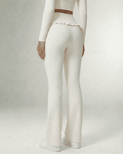 Celeste Leggings by Slimona, elegant white flare pants with pockets, back view showcasing high waist and ruffle detail.