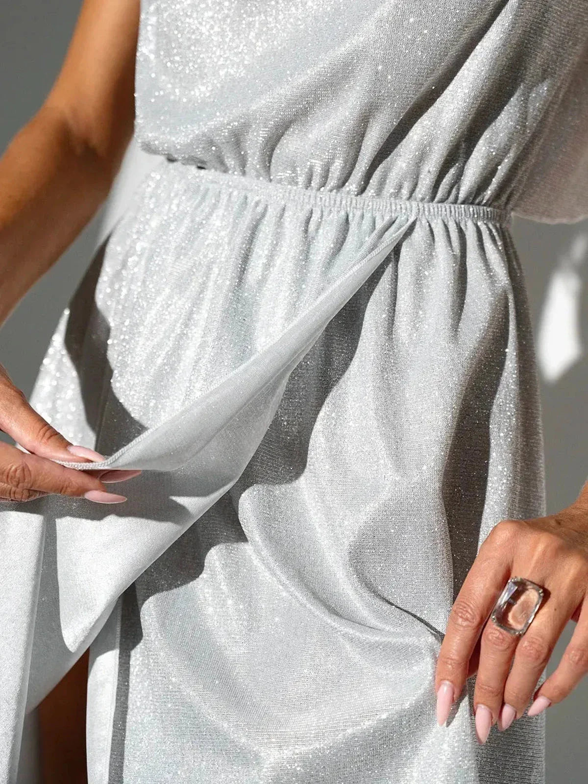 Close-up of the Celestial Glow Midi Dress showcasing shimmering fabric and an elastic waist, perfect for summer and wedding guest attire.
